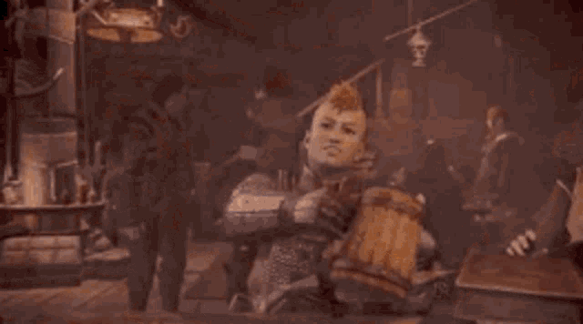 a man with a mohawk sits at a table holding a wooden mug