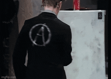 a man in a suit with a anarchy symbol on his back