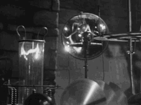 a black and white photo of a room with a clock and a lamp