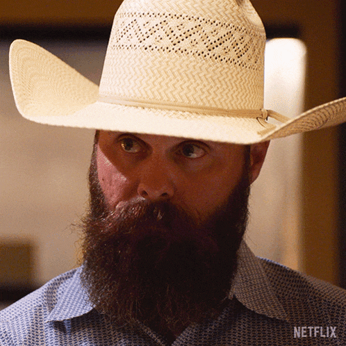a man with a beard wearing a cowboy hat and a netflix logo