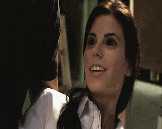 a close up of a woman 's face smiling