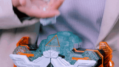 a person is holding a toy that has a pyramid in the middle