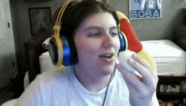 a man wearing headphones is eating an egg in a video game .