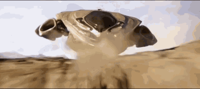 a robot is flying through the air in the desert