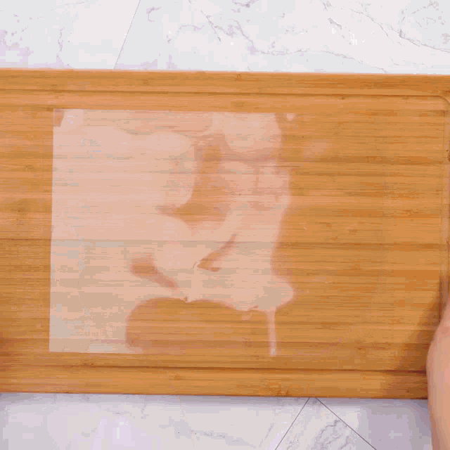 chocolate is being poured onto a piece of wax paper