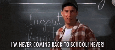 a man standing in front of a blackboard with the words i 'm never coming back to school never written on it