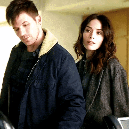 a man and woman are standing next to each other