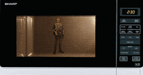 a sharp microwave shows a man holding a gun inside