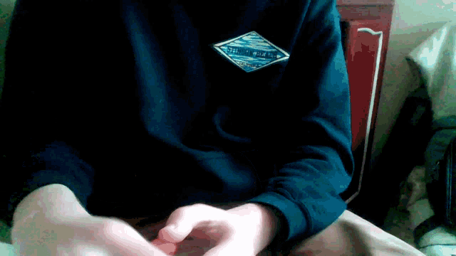 a person wearing a black sweater with a patch on the back that says ' columbia ' on it