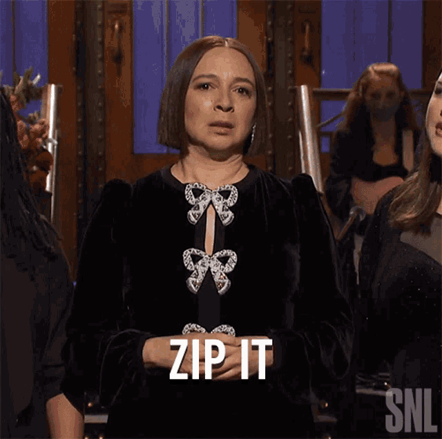 a woman in a black dress says zip it on snl