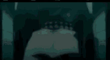 a man is walking down a hallway with hearts and diamonds on his back .