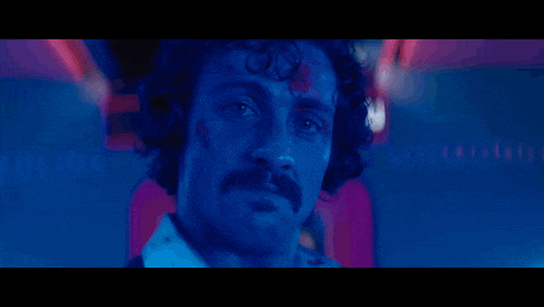 a close up of a man 's face with blood on his face