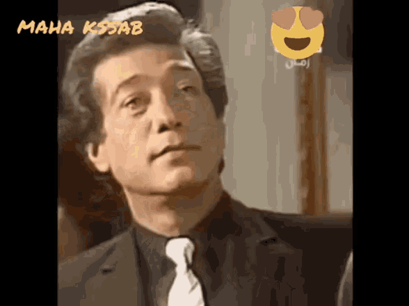 a man in a suit and tie with hearts in his eyes is shown