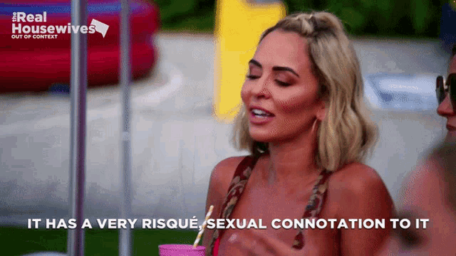 a woman says it has a very risque sexual connotation to it while holding a drink