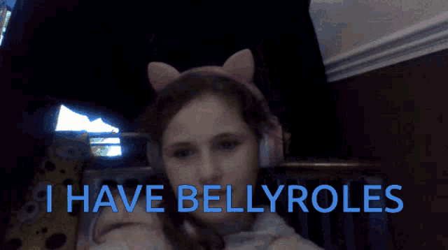 a girl wearing headphones says " i have bellyroles " in blue letters