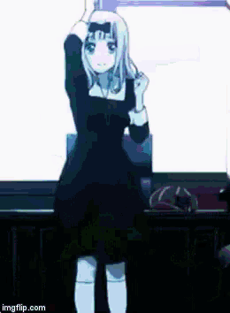 a girl in a black dress is dancing in front of a white background .