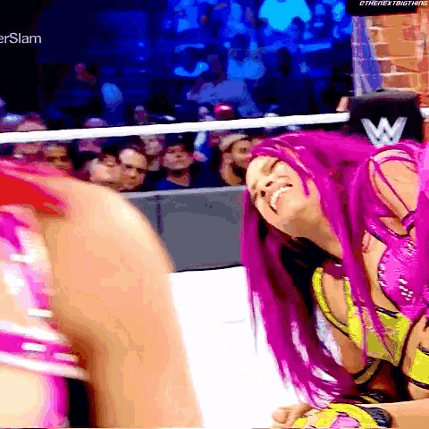 a woman with purple hair is smiling in front of a crowd and a sign that says ethenextbigthing