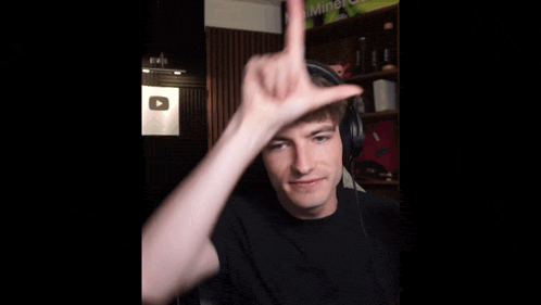 a man wearing headphones is making a hand gesture