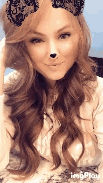 a woman wearing a lace headband with a cat nose on it