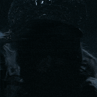 a close up of a woman 's face with a hat on