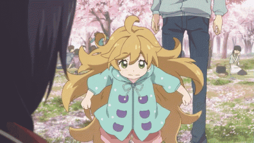 a little girl with long blonde hair is wearing a blue jacket with purple letters on it