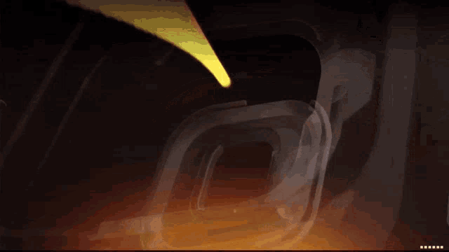 a dark background with a yellow light coming out of the corner