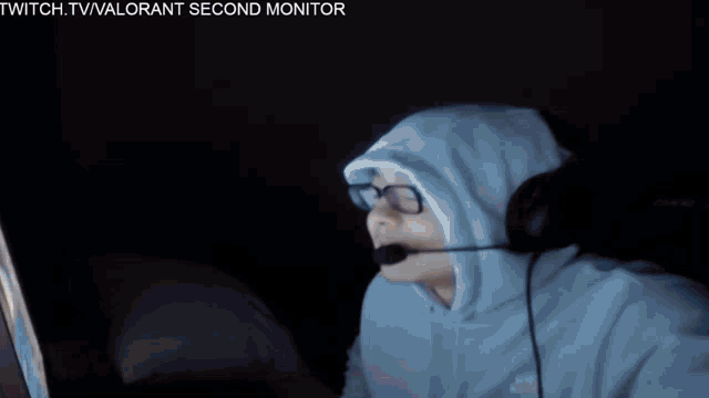 a man wearing headphones is sitting in front of a dxr chair