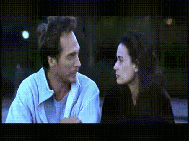 a man and a woman are looking at each other and talking