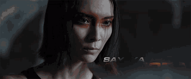 a close up of a woman 's face with sayaka akimoto written above her