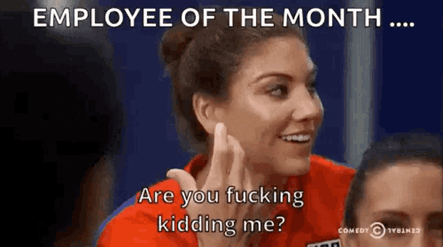 a woman in a red shirt is talking to another woman in a blue shirt .