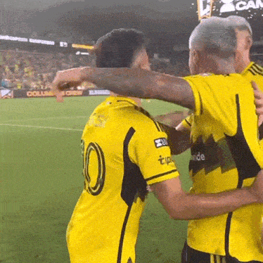 a soccer player with the number 10 on his shirt is hugging another player