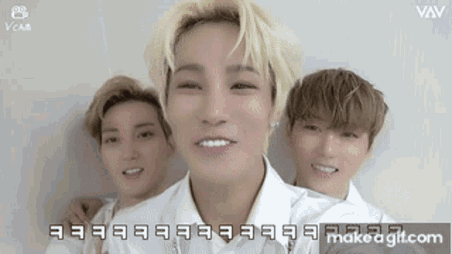 a group of young men are standing next to each other and one of them is smiling
