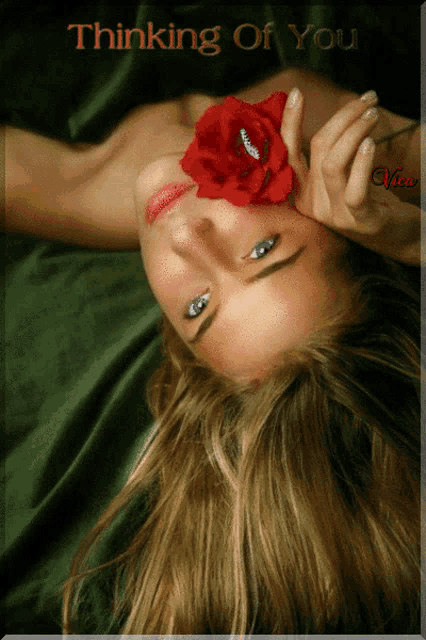a picture of a woman with a red rose in her mouth and the words thinking of you