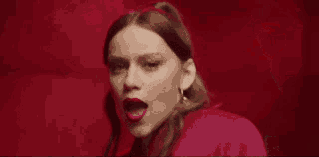 a woman wearing a pink bra and a pink jacket