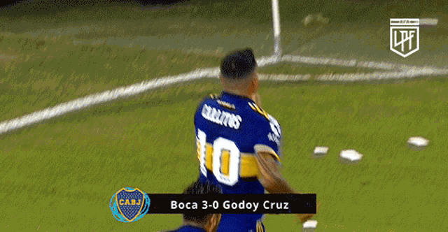 a soccer player wearing a number 10 jersey is celebrating a goal