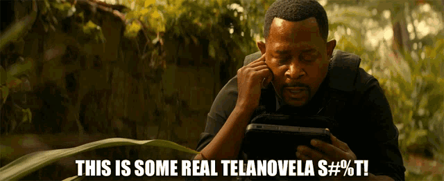 a man is holding a tablet and says this is some real telanovela
