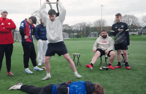 a man wearing a sweatshirt that says supreme is lifting a bar