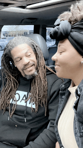 a man with dreadlocks is wearing a black hoodie that says " oa "