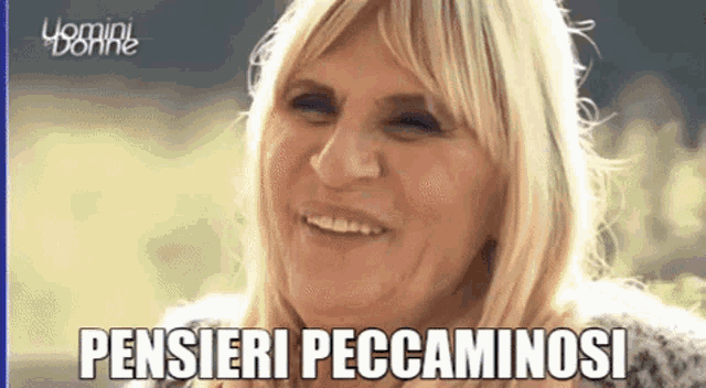 a close up of a woman 's face with the words pensieri peccaminosi above her
