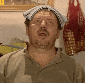 a man with a towel on his head is making a face