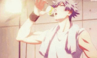 a man is drinking water from a bottle in a locker room .