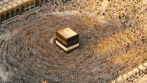 a large crowd of people are gathered around a mosque