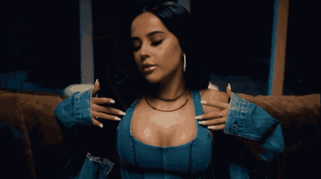 a close up of a woman wearing a blue top