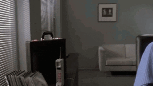 a briefcase sits on a desk in a living room