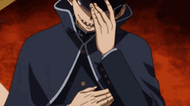 a man with a cross on his hat is covering his face