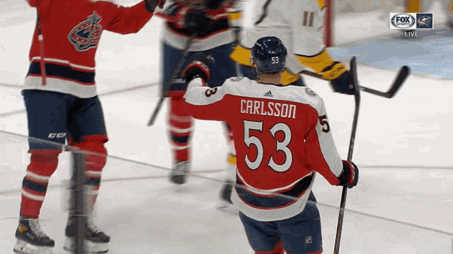 a hockey player wearing a jersey with the number 53 on it