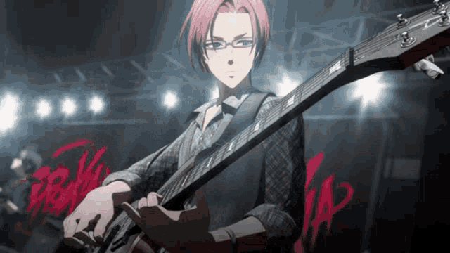 a man with pink hair is playing a guitar on stage