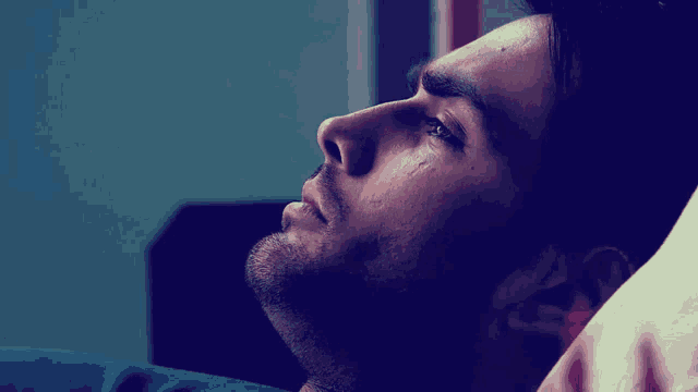 a man with a tear running down his cheek