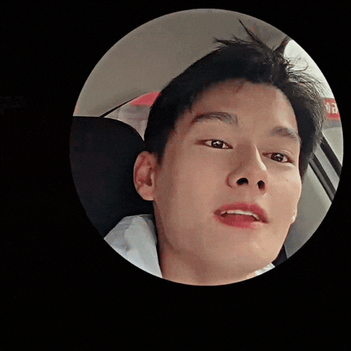 a close up of a man 's face in a car