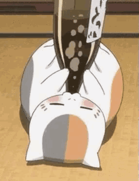 a cartoon cat is laying on its back drinking a bottle of soda .